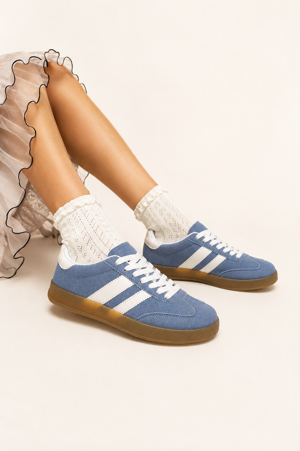 Blue suede retro sneakers with white stripes and gum sole